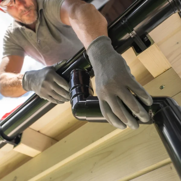 worker-installing-gutter-system-on-roof-2026-01-09-00-20-24-utc